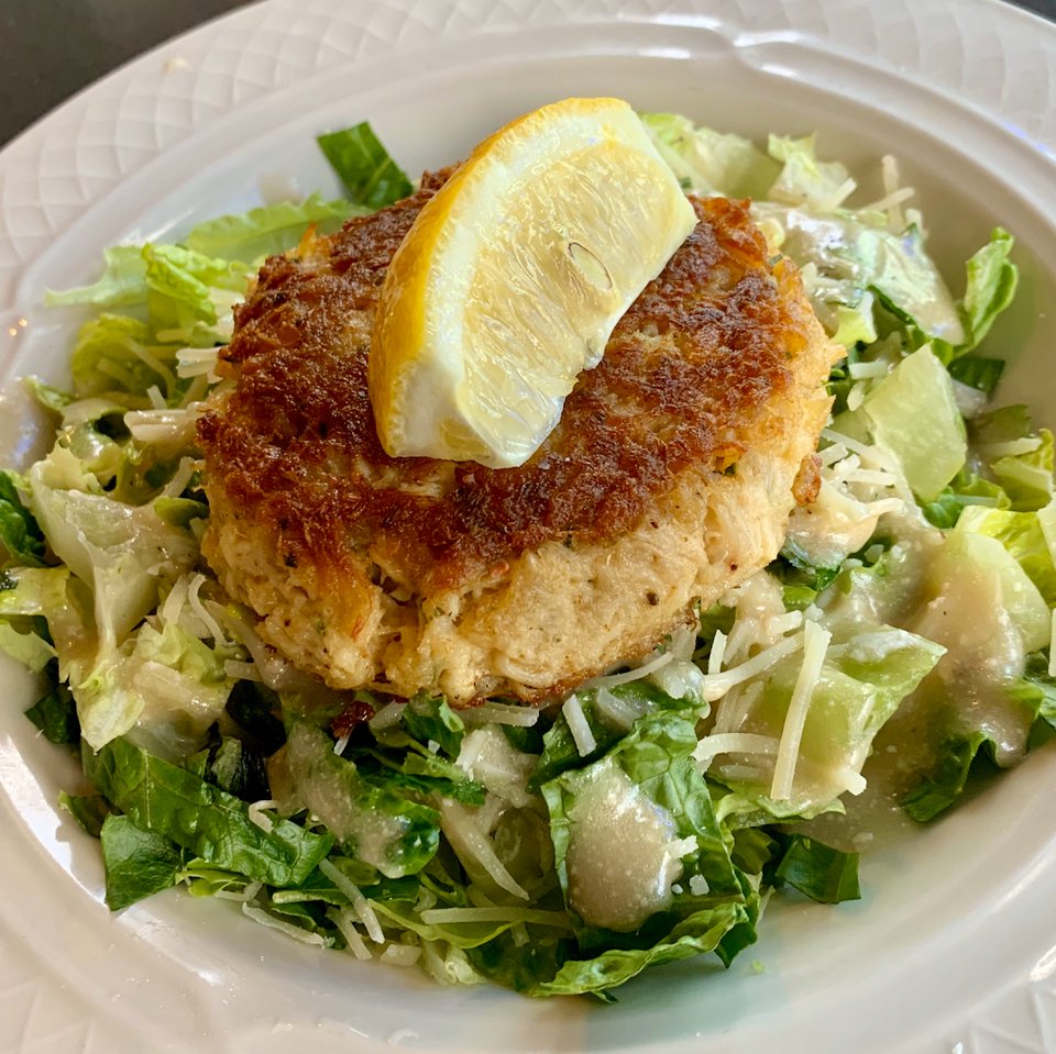 Crisp seafood plates served with lemon wedges.