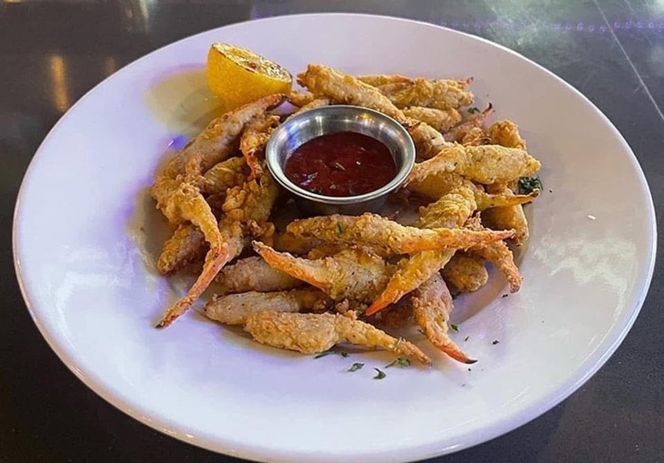 Plated seafood dishes on a casual restaurant table.